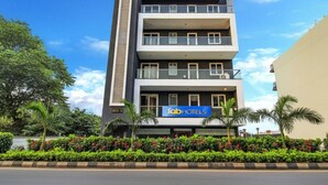 A multi-story building with a sign for 'Fabo Hotels'. - Fabhotel Kiara (Gurugram)