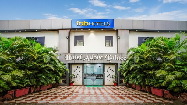 A modern building with a checkered floor pattern and a sign reading "fabHOTELS Hotel Adore Palace". - Fabhotel The Adore Palace (Mumbai)