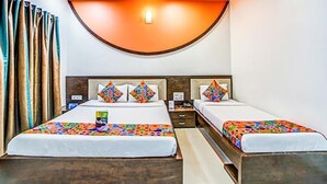 A hotel room with two beds, a wooden headboard, and a curved ceiling light. - Fabhotel The Adore Palace (Mumbai)