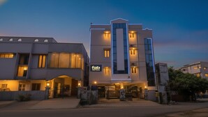 A modern hotel with a prominent entrance, a sign for 'fad hotels', and a well-lit facade. - Fabhotel Aditya Yatri Nivas (Tirupati)