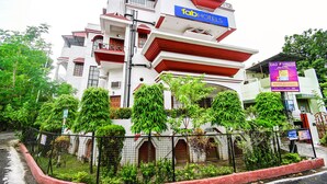 A multi-story hotel with a prominent 'fab hotels' sign, featuring balconies and a traditional architectural style. - Fabexpress Ullash Residency (Barasat)