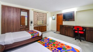 A hotel room with two beds, a TV, a desk, and a chair. - Fabexpress Ullash Residency (Barasat)