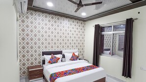A bedroom with a bed, nightstand, and a ceiling fan.