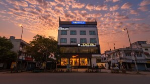 A modern building with a 'fabHOTELS' sign, 'TATVA' branding, and a Nike logo. - Fabhotel Resolute (Jaipur)