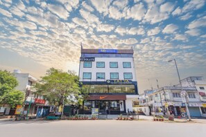 A multi-story building with a 'fabHOTELS' sign, 'TATVA' branding, and a 'RESOLUTE' sign. - Fabhotel Resolute (Jaipur)