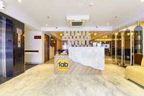 A hotel lobby with a reception desk, a bar sign, and a 'fab hotels' logo. - Fabhotel Prime The Wish (Jaipur)