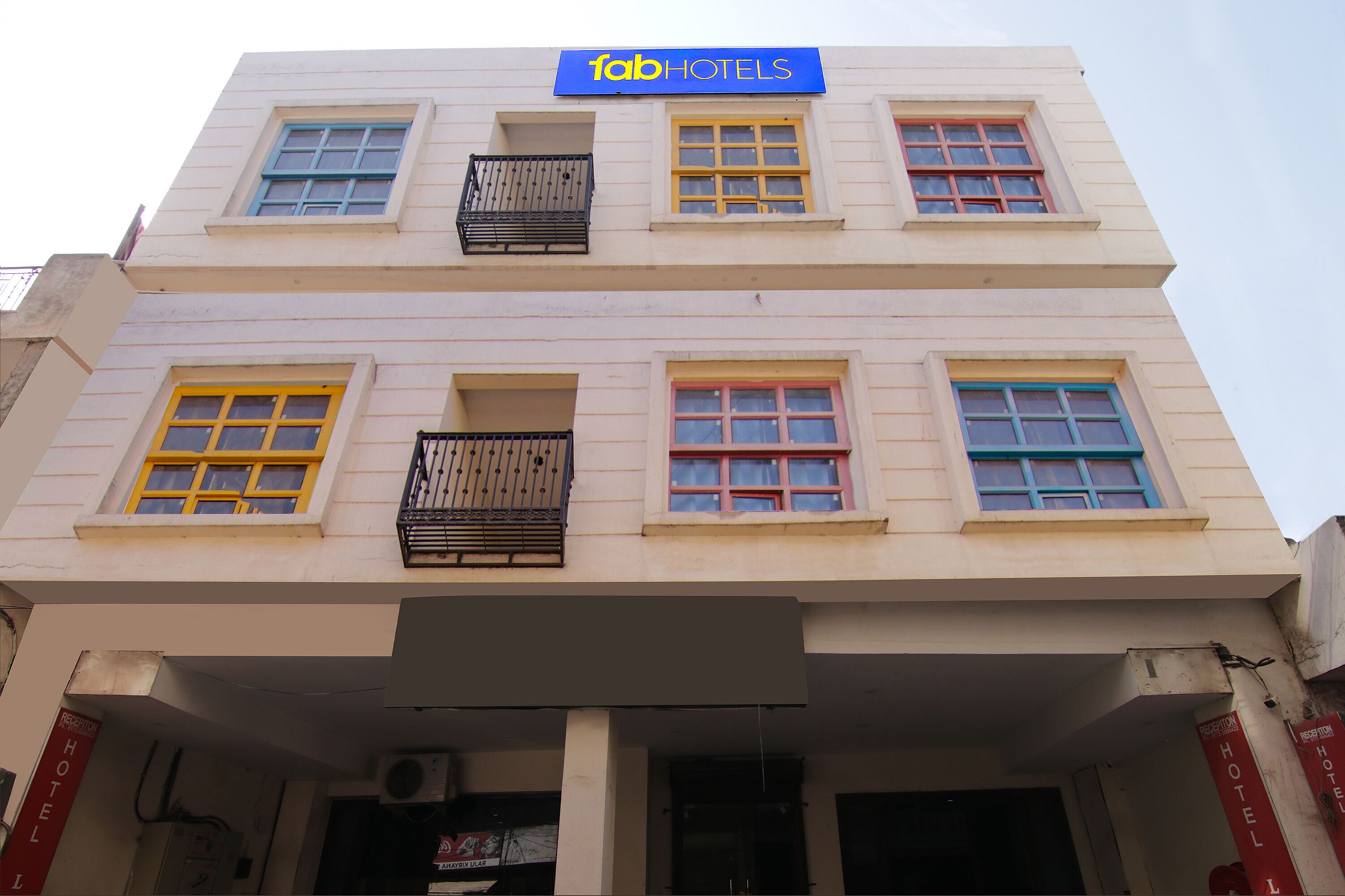 A multi-story building with a sign reading "fab hotels".