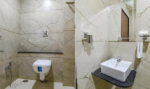 A bathroom with a toilet, a sink, and a mirror. - Fabhotel Elite Residency (Indore)