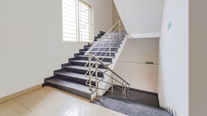 A staircase with metal railings and a window with bars. - FabHotel Chris - Whitefield near KTPO & ITPL (Bengaluru)