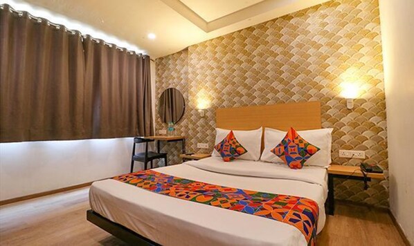 Relax in a stylish room with a large bed, wooden headboard, and a nightstand with a lamp.