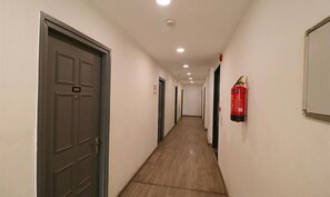 Corridors feature numbered doors and a fire extinguisher for added safety.