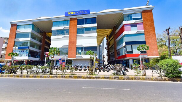 A multi-story building with a 'Tab Hotels' sign, featuring a modern architectural design with glass and brick elements. - Fabhotel Infinity (Vadodara)