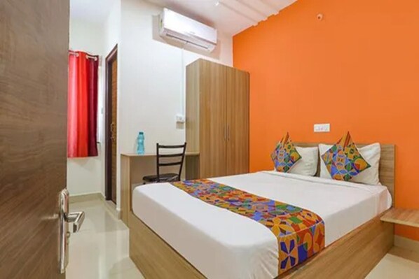 A bedroom with a bed, a desk, and a wardrobe. - Via Athidhi Stay Inn (Hyderabad)