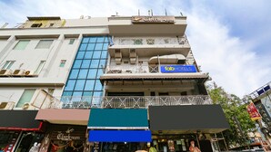 A multi-story building with a sign for 'Clark Heights' on the top floor. - Fabhotel Clark Height (New Delhi)