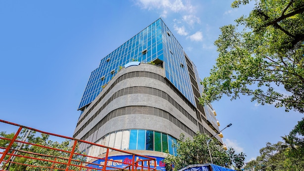 A modern building with a curved facade and large windows. - Fabhotel Azure (Mumbai)