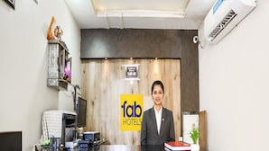 A hotel reception desk with a modern design, a digital display, and a sign for 'fab hotels'. - Fabhotel Welcome (Kanpur)