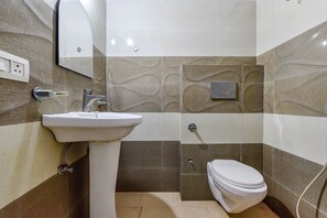 A bathroom with a sink, toilet, and mirror. - FabHotel Green Vista Malviya Nagar (Jaipur)