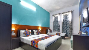 A modern hotel room with a large bed, bedside lamps, a desk, and a TV. - FabHotel Green Vista Malviya Nagar (Jaipur)