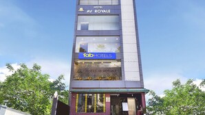 A modern hotel building with a sign for "Hotel AV ROYALE" and "Fab Hotels" branding. - FabHotel Prime AV Royale (Dehradun)