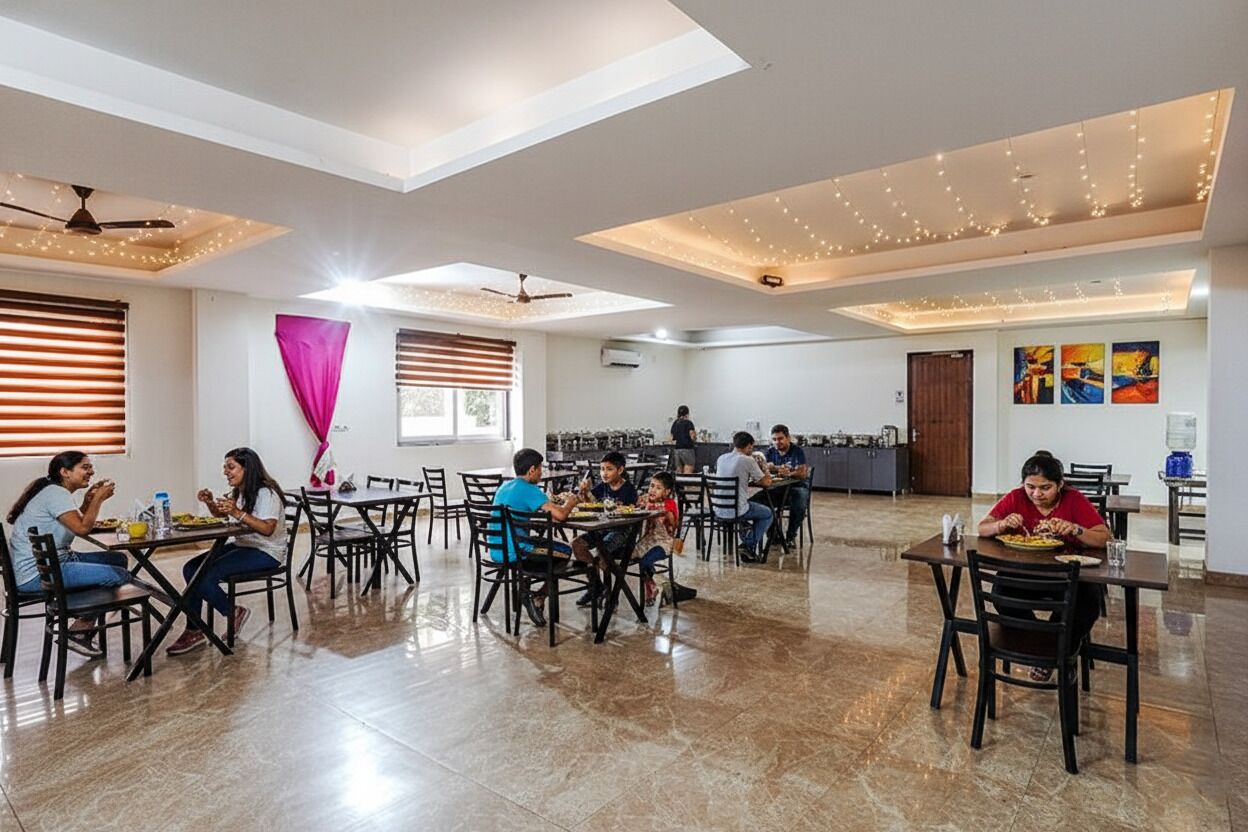 A spacious dining area with multiple tables and chairs, ceiling fans, and string lights.