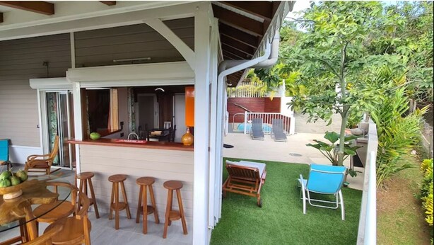A covered outdoor area with a pool, bar, and seating. - Luxury villas with private pools in the countryside (Le Marin)