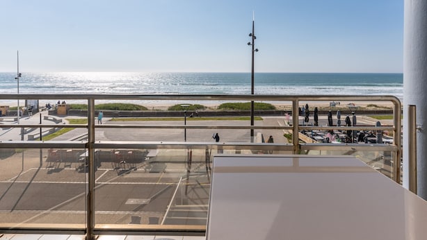 A view from a balcony overlooking a beach with a clear sky. - Mimizan Beach: 6-person apartment with balcony and parking (Mimizan)
