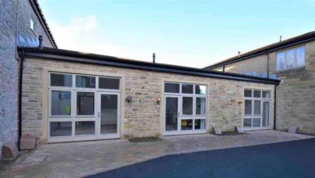 A building with two large glass doors and a paved driveway. - Smithy Bungalow, Free Private Parking (Buxton)
