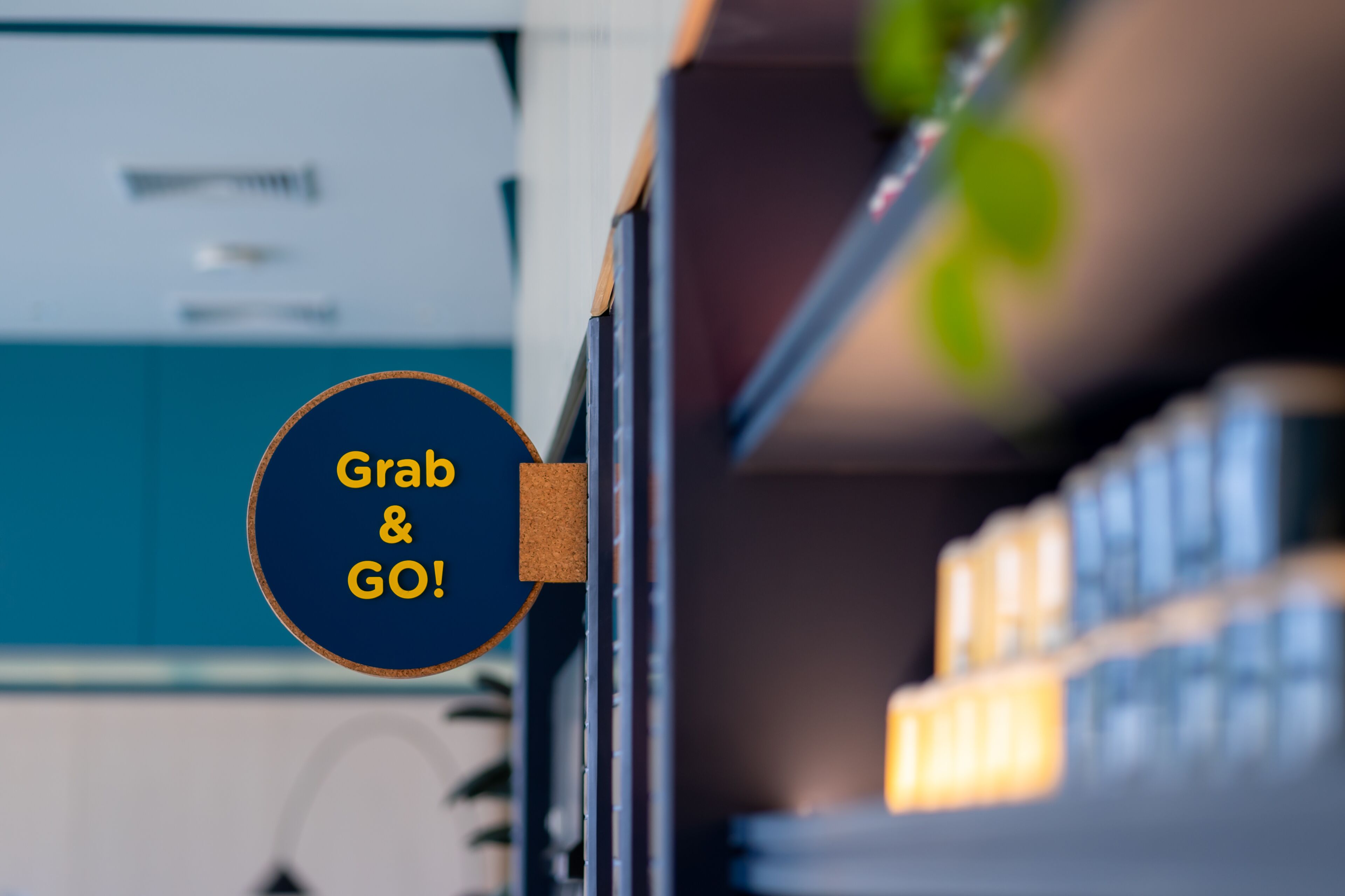 A sign with the text "Grab & GO!" on a blue background.