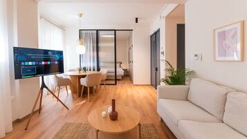 Comfort Apartment, 1 Queen Bed | Living area | 50-inch Smart TV with cable channels