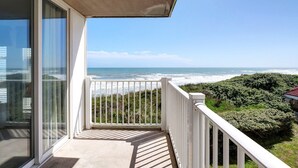 A balcony with a view of the ocean and a beach. - Oceanfront Point Unit with 3 Bedrooms and Great Oceanviews (North Topsail Beach)