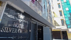 Entrada de un hotel con un cartel que dice 'Hotel Silver Crown'.