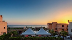 A coastal hotel with a view of the sea, featuring white tents and outdoor seating. - La Risacca Relais  (Belvedere Marittimo)