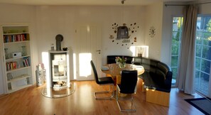 Cozy living space with a dining area, bookshelf, and door to another room.