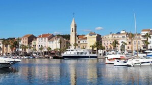 A marina with boats docked, a prominent tower, and buildings with balconies. - Les Terrasses d'Azur by Interhome (Sanary sur Mer)