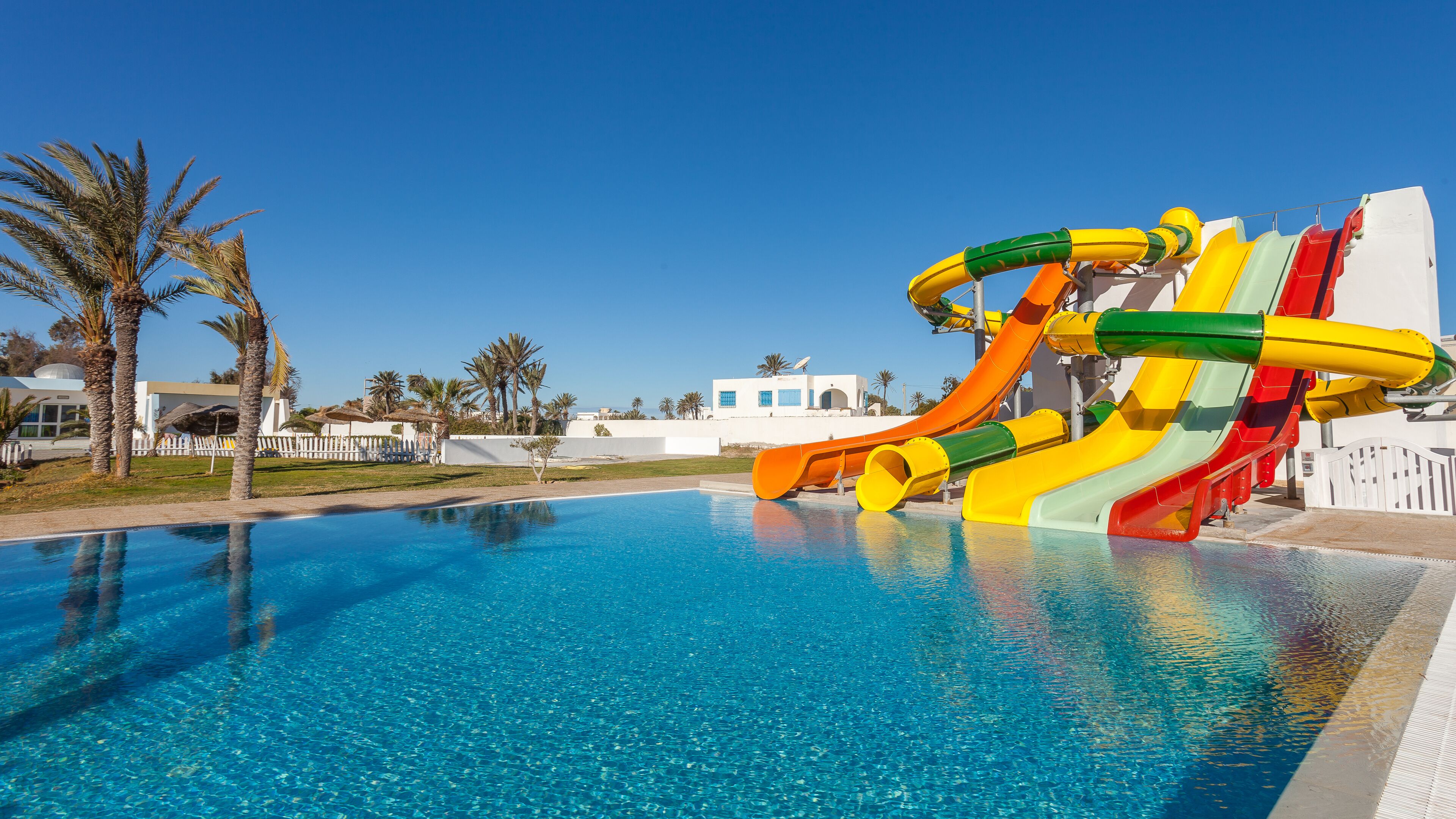 A swimming pool with a water slide.