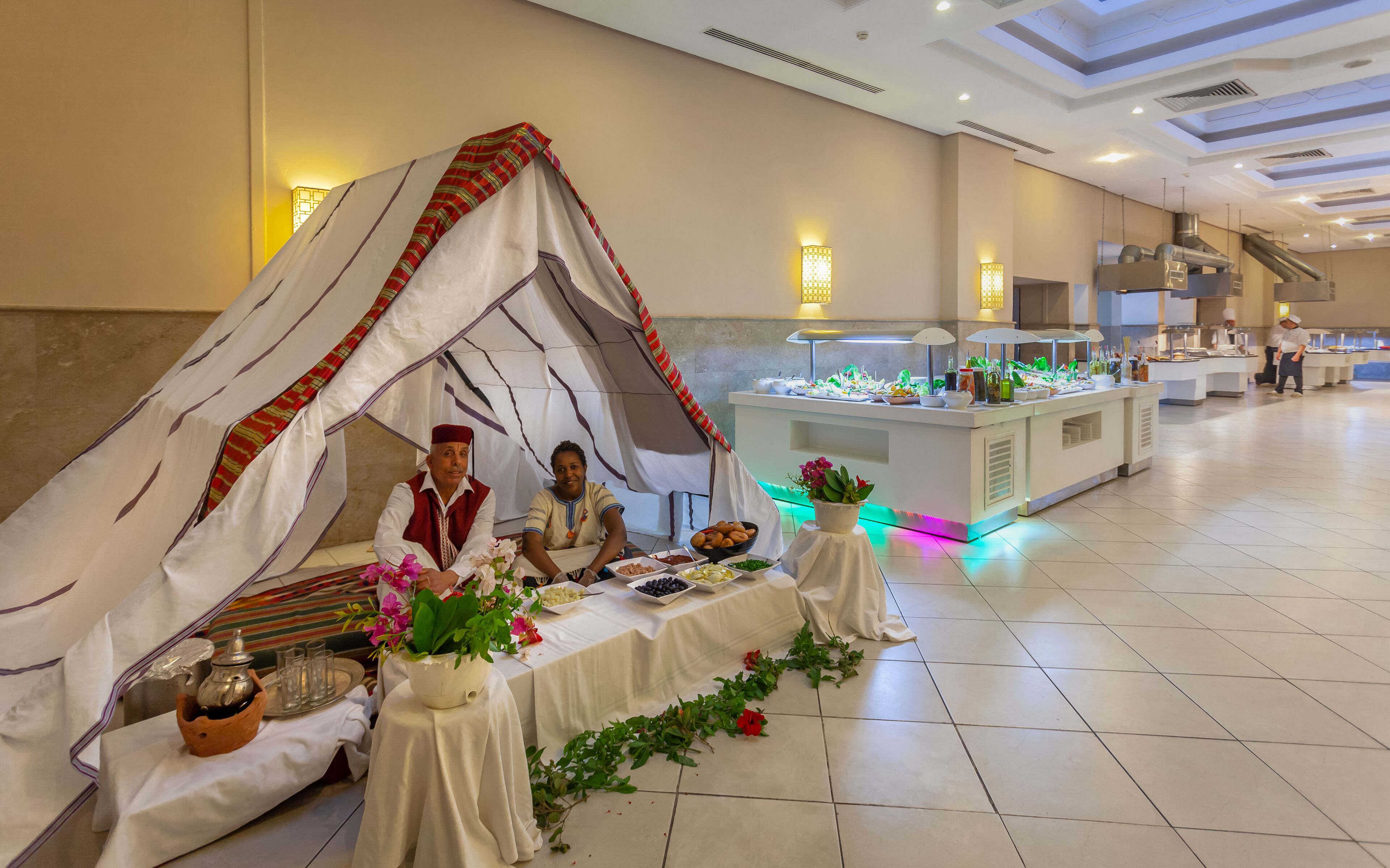 A buffet setup with a tented area and a buffet counter in a hotel setting.