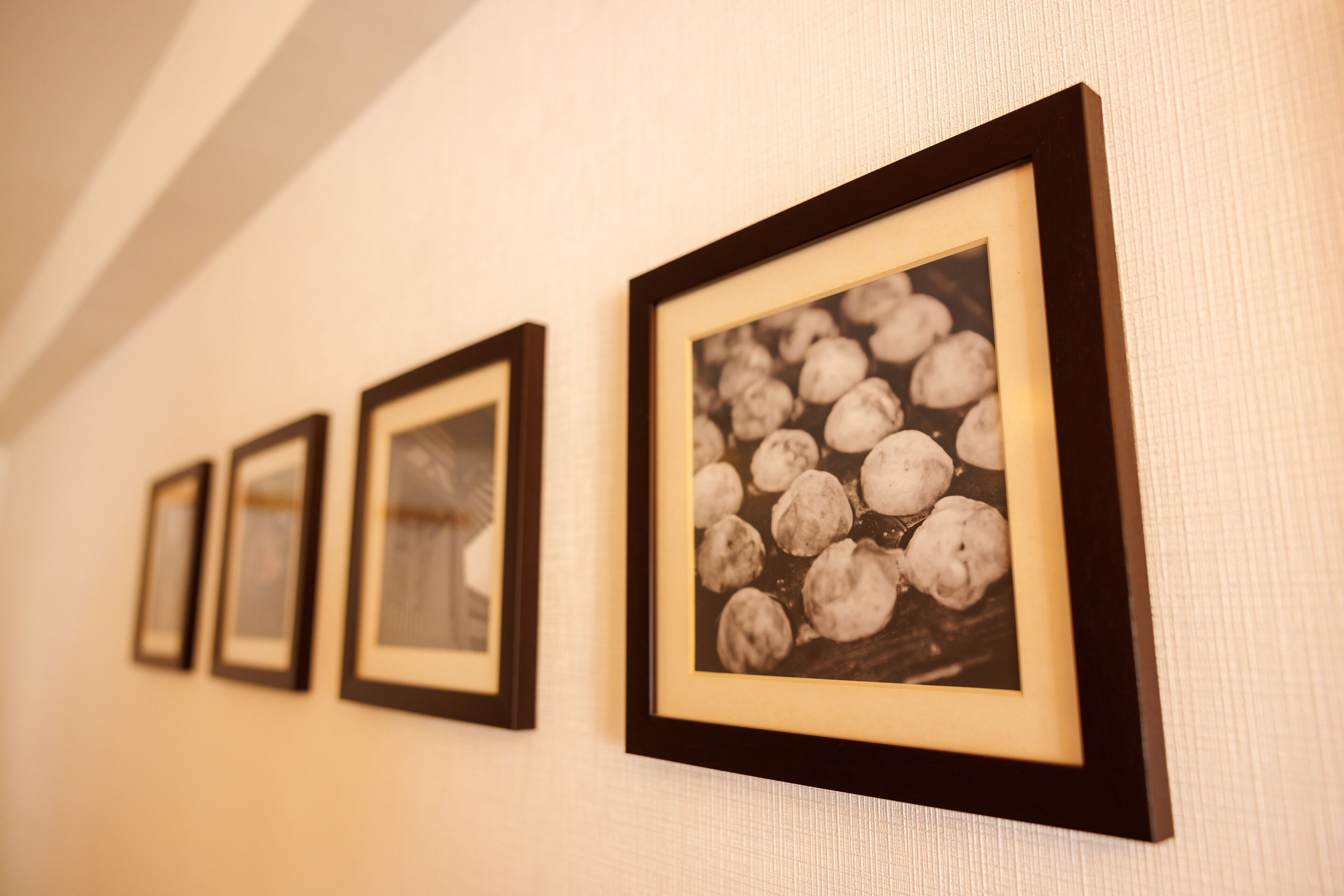 A hallway with framed pictures on the wall.