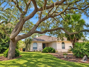 A residential property with a large tree in the foreground, a well-maintained lawn, and a house with a number 5324. - Paradise by the River - Relax in Style Near the Beach! Pool and Heated Spa (St. Augustine)