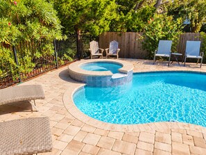 A swimming pool with a hot tub, surrounded by lounge chairs and a wooden fence. - Paradise by the River - Relax in Style Near the Beach! Pool and Heated Spa (St. Augustine)