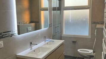 Shower, hair dryer, towels, toilet paper