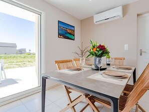 Enjoy meals in this dining area with a large table for four and comfortable seating.