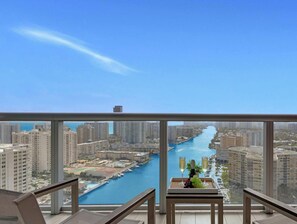 A high-rise building with a view of a river and other buildings.