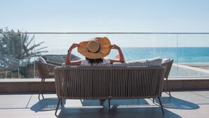 A person sitting on a wicker chair with a view of the ocean. - Amber El Fell- Boutique Hotel (Hammamet)