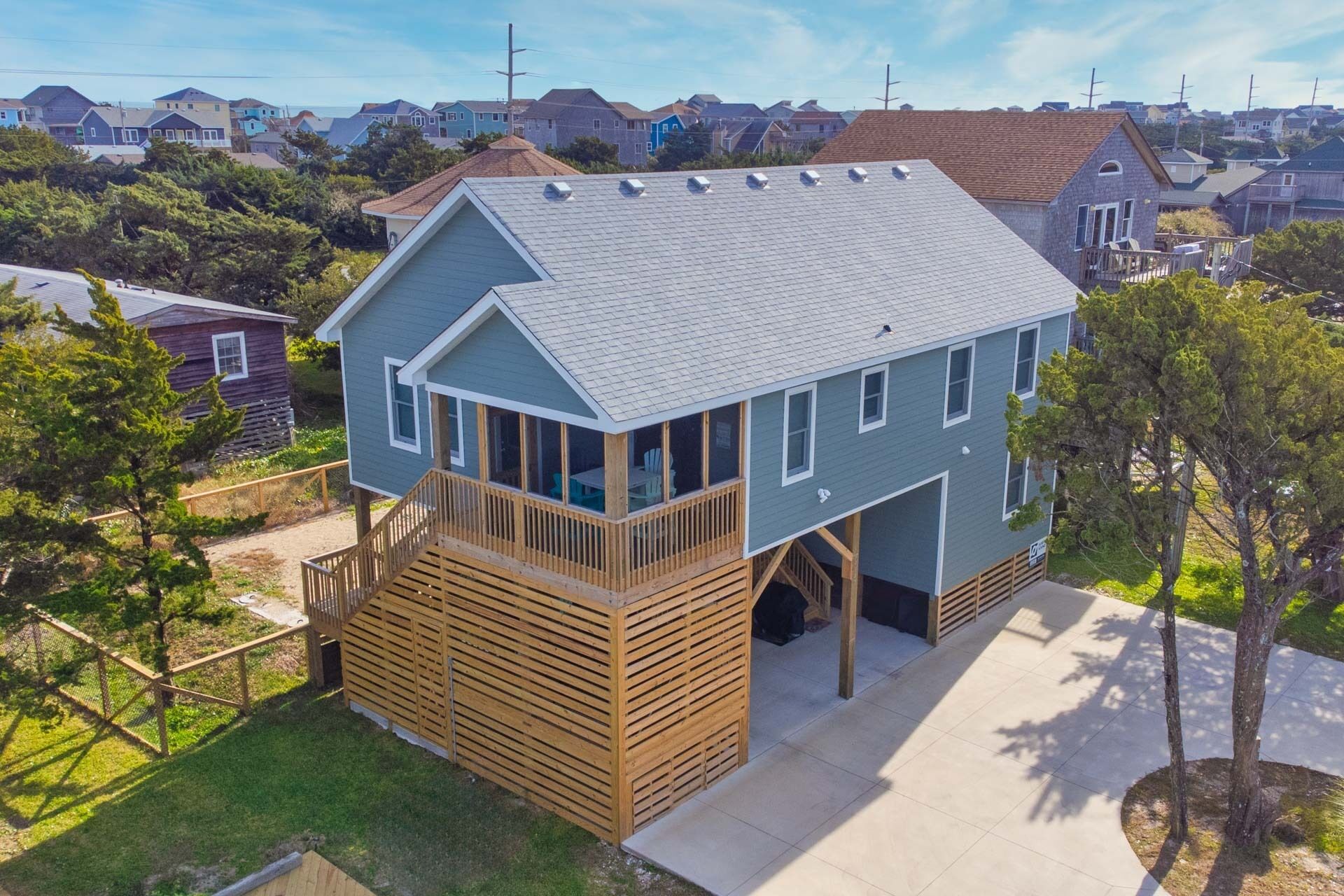A two-story house with a wooden deck and a covered porch.