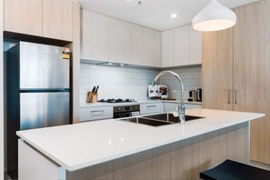 Enjoy cooking in this well-equipped kitchen with a sink, gas stove, and ample storage.