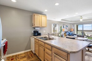 Enjoy a comfortable stay in this well-appointed kitchen and living area, featuring a central island, oven, and comfortable seating.