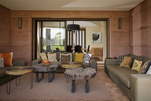 A modern living room with a sofa, two coffee tables, and a large window. - MISH-MISH (Marrakech)