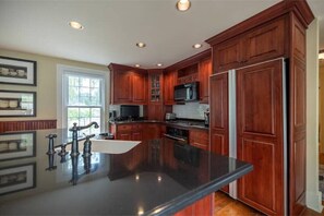 Enjoy cooking in this well-equipped kitchen with a central island and ample natural light.
