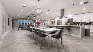A spacious kitchen with a large island, modern appliances, and ample lighting. - Stunning Lake View, Heated Pool, Single Story! (Boulder City)