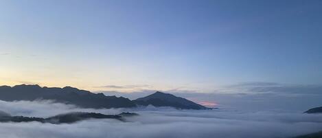 A mountainous landscape with a clear sky and a sunrise or sunset.